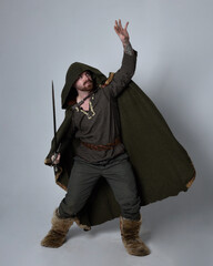 Full length  portrait of  young handsome man  wearing  medieval Celtic adventurer costume with...