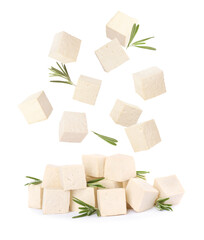 Cubes of raw tofu falling into pile on white background