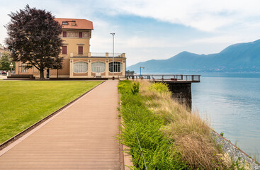 Fototapeta na wymiar Luino lakefront with Verbania Palace on the shore of Lake Maggiore, province of Varese, Italy