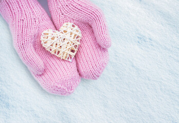 Female hands in mittens with heart, close-up