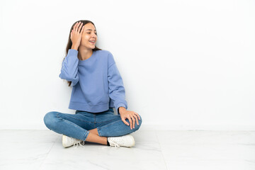 Young French girl sitting on the floor has realized something and intending the solution
