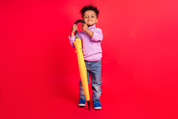 Full length body size view of attractive preteen cheerful kid holding parasol clear good day isolated over bright red color background