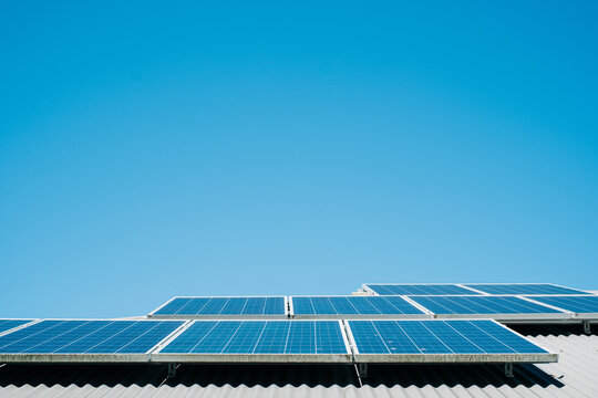 horizontal shot of solar panels with blue sky in the background