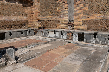 Latrina presso le terme del foro. Ancient public toilets (latrines) located at Ostia Atica (the...