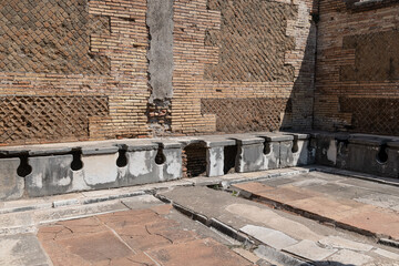 Latrina presso le terme del foro. Ancient public toilets (latrines) located at Ostia Atica (the...