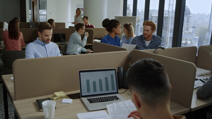 Multi ethnic coworkers working in open space. Business people working in office