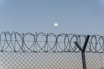 Airport security fence at sunset, Kabul, Afghanistan