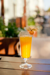 glass of mango orange cocktail on the table