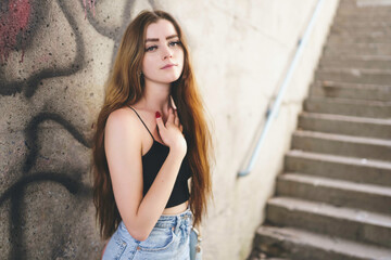 Nice and cool teen girl standing portrait on concreate place