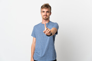 Young handsome man isolated on white background showing and lifting a finger