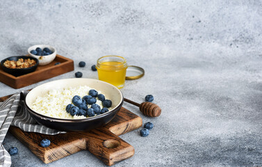 Cottage cheese with honey and berries for breakfast. Granola with cottage cheese and nuts.