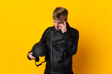 Man with a motorcycle helmet isolated on yellow background laughing