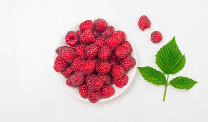 Fresh organic raspberries on white background top view.