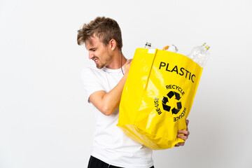 Young blonde man holding a recycling bag full of paper to recycle isolated on white background...
