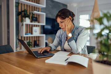 Exhausted woman working overtime at home.