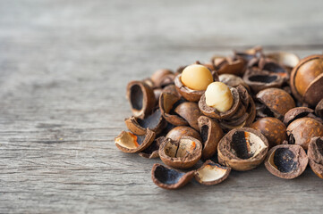 Pile of peeled Macadamia nuts on wooden table