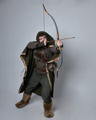 Full length  portrait of  young handsome man  wearing  medieval Celtic adventurer costume with...