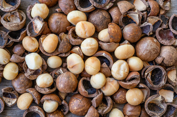 Pile of peeled Macadamia nuts on wooden table