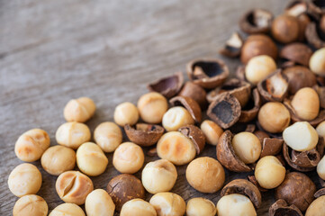 Pile of peeled Macadamia nuts on wooden table
