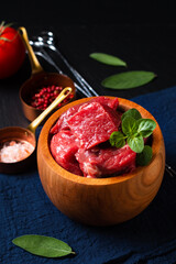 Food concept Farmer organic Raw cube cut beef meat in wooden bowl with copy space