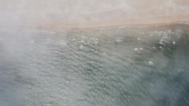 Aerial view vertically down the sea sandy beach.