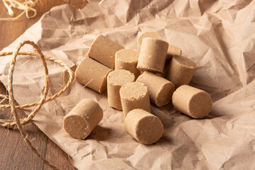 Peanut candy (paçoca or pacoca) Traditional Brazilian peanut-based candy, arranged on brown paper on a table. Selective Focus.