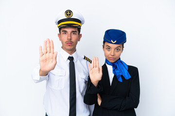 Airplane pilot and mixed race air hostess isolated on white background making stop gesture denying...