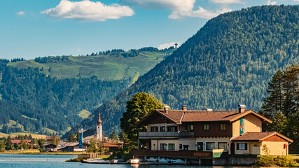 Naklejka premium Beautiful alpine summer view with reflections and the famous Jacob cross in the background at the famous Piller lake, Tyrol, Austria