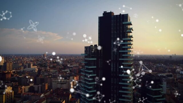Animation of connections moving over modern cityscape at sunset