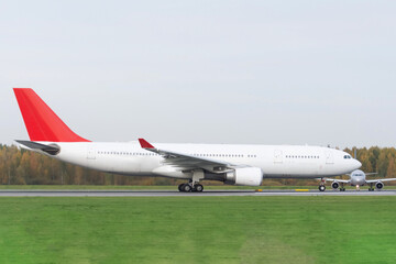 Two planes on the tarmac before takeoff from the runway.