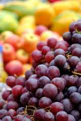 Vertical close-up shot of fresh grapes on display at outdoor farmers market in Panama City