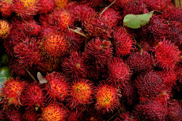 Close-up shot of Chinese rambutan hairy fruit at a street stall