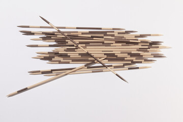 Japanese Board game Mikado. Bamboo sticks from the game on a white background. Top view, macro