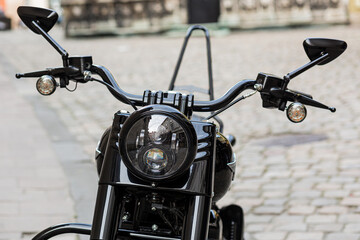 Fototapeta premium Part of a retro black motorcycle with a large headlight