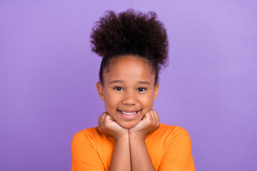 Photo of young pretty little afro girl happy positive smile hands touch chin dream isolated over...