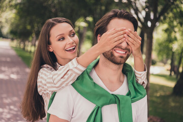 Fototapeta premium Photo portrait couple spending time in park playful mood girl closing eyes her boyfriend