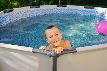 child in pool. Summer. Refreshing procedure. Sunny Day 