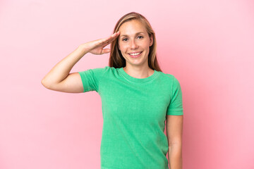 Young English woman isolated on pink background saluting with hand with happy expression