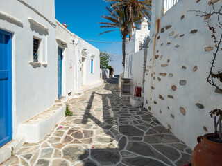 Whitewashed houses blue doors cobblestone street at Kastro village Sifnos island Cyclades Greece.