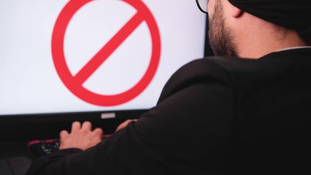 hacker man typing on the keyboard is getting banned on the social media and angry punching on the table