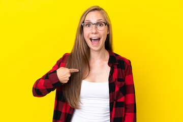 Young English woman isolated on yellow background with surprise facial expression
