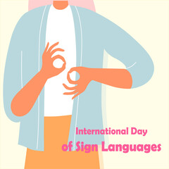The girl shows a gesture with her hands. Inscription International Day of Sign Languages. Vector flat illustration