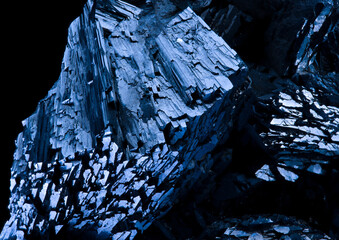 Blue Pyrite mineral on a black background, close up. Mineral stone pattern and texture. Selective...