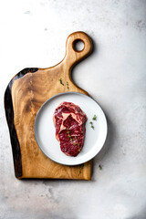 Slices of steak on dark wooden board