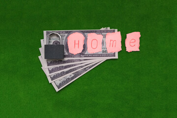 The word house, American dollar bills, a castle on a green background. Real estate market, sale, purchase of housing.