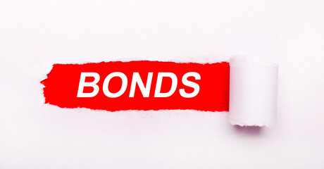 On a bright red background, white paper with a torn stripe and the inscription BONDS.