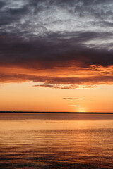Photo of a Summer Sunset on the Lake. Travel location of popular tourist outdoor. View of beautiful Sea Landscape. Relax vacation near water