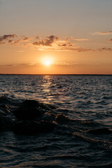 Photo of a Summer Sunset on the Lake. Travel location of popular tourist outdoor. View of beautiful Sea Landscape. Relax vacation near water