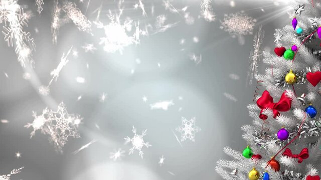 Animation of decorated white christmas tree, with falling snowflakes and glowing lights on grey