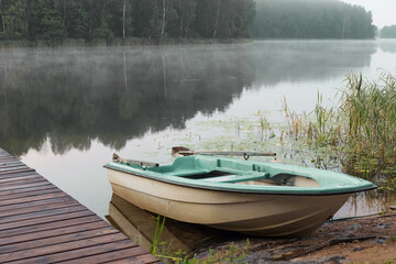 summer beautiful landscape with  boat on lake  at sunrise